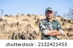 Confident smiling indian soldier in uniform standing with arms crossed by looking at camera with copy space - concept of successful, proud serviceman and occupation.