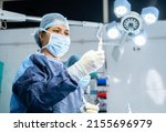 Small photo of surgeon preparing anaesthesia syringe or injection for surgery at operation theatre - concept of safety, expertise and healthcare specialist