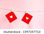 
Red hearts set on string on a pink background. Valentine's concept. Space for text
