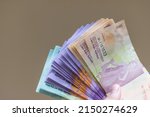 Small photo of Indonesian currency (IDR) on isolated background. Payout or gajian. Tunjangan Hari Raya (THR) or holiday allowance. Earn or profit. Money exchange to IDR