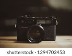 Small photo of Dubai, uae - jan 25 2019: vintage antique camera on wooden table , yashica electro 35 gtn