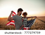 Father and daughter holding American flag