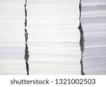 Small photo of piles of white printing paper in printing office