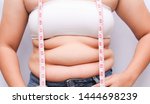 Small photo of Beautiful fat woman with tape measure She uses her hand to squeeze the excess fat that is isolated on a white background. She wants to lose weight, the concept of surgery and break down fat under the