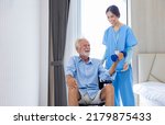 Small photo of Hospice nurse or professional caregiver is helping Caucasian man in the wheelchair to exercising muscle strength in pension retirement center for home care rehabilitation and longevity post treatment