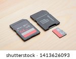 New fast memory cards on table. SD and micro sd card with adapter on wooden table