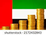 Small photo of Upgoing graph made of coins stacked in front of United Arab Emirates flag. Concept of quick financial development of United Arab Emirates