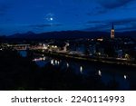 Moonlight night over the Karawanken alpine ridge and the ancient Austrian city of Villach with a view of the city church