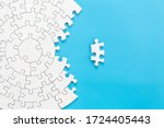 White jigsaw puzzle pieces on a blue background. Problem solving concepts. Texture photo with copy space for text