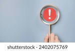 Small photo of Attention caution warning concept. Magnifying glass focus on red page with exclamation error mark for important alert signal, Hazard, risk ,danger background with copyspace.