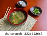 Small photo of miso soup or Japanese miso soup in bowl on the table. Japanese cuisine in the form of soup with dashi ingredients, tofu, seafood, vegetables, and topped with miso to taste