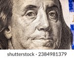 Small photo of Benjamin Franklin's face on the US 100 dollar bill. Closeup of Ben Franklin on a one hundred dollar bill. Benjamin Franklin portrait from hundred dollar bill macro