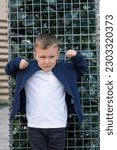 Small photo of Child with angry expression. Angry hateful little aggression boy, child furious. Angry rage kids face. Anger child with furious negative emotion portrait. Aggressive and mad kid bad behavior.