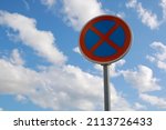 No Parking Traffic Road Sign. The urban clearway sign with blue sky cloudy background