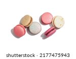 Different colorful French macarons isolated on white background. Culinary and cooking concept. Tasty baked food, assorted confectionery range, top view