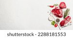 Small photo of Set of various steaks with spices and herbs. Classic raw meat cuts includes ribeye, eye round and striploin steaks. Plaster white background, flat lay, banner format