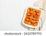 Oven baked pumpkin slices with honey, rosemary and seeds. Healthy vegan food, trendy hard light, dark shadow. White background, flat lay, top view