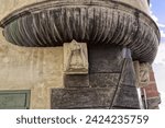 Small photo of Krems an der Donau, Austria - 01 27 2024: The figure of a man looks from the former Roman trading house onto the parish square, his female counterpart on the right looks to the other side