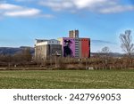 Small photo of Korneuburg, Austria - 02 18 2024: Distant view of a granary that stands out from the gray monotony with a huge work of art by the Tyrolean artist Golif