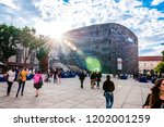 Small photo of Vienna, Austria - June 14, 2014: Sunrays above the Mumok museum. People moving between MQ social zones. Museumsquartier or MQ is a large area in the city of Vienna, Austria