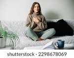Small photo of Relaxation techniques: Woman practicing pranayama in lotus position on bed, breathing exercises to reduce stress and anxiety, achieving inner balance and harmony, mindfulness and meditation practice
