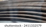 Small photo of A lot modern black plastic spiral hoses closeup. Helical polymer wire reinforced pipes