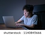 Small photo of Sleepy exhausted young Asian man working late night with his laptop, aggressive working don’t like the job and want to quite so much, sleep deprivation and overtime overload working concept.