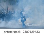 Small photo of Riot police uses tear gas to disperse the crowd during the May Day labour march, a day of mobilisation against the French pension reform law and for social justice, in Paris, France May 1, 2023.