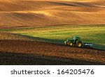 Tractor Plows A Field In The...