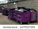 Small photo of London / England - March 21st 2020: Weeks of uncollected overflowing rubbish bags in large purple bins in Tower Hamlets, East London. Due to Covid-19 Coronavirus outbreak workers are self-isolating.