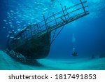 Women diver explores the wrecks at the Bridge dive site on the island of Sint Maarten, Dutch Caribbean