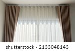 Small photo of fabric curtain and white sheer curtains with translucent fabric hanging on door