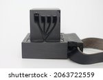 Small photo of Tefillin -[Jewish phylactery] with black straps on a white background. Two black boxes, one with the Hebrew letter Shin on the side, long ribbons. Jewish traditional religious items for male prayers