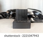 Small photo of Tefillin -[Jewish phylactery] with black straps on a white background. Two black boxes, one with the Hebrew letter Shin on the side, long ribbons. Jewish traditional religious items for male prayers