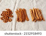Small photo of Crunchy Salty Baked Pretzel Sticks, Pretzel Rods and Pretzel Crackers, side view.