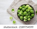 Raw Organic Brussel Sprouts in a Bowl, top view. Flat lay, overhead, from above. Copy space.