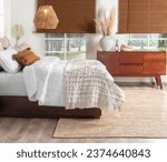 Small photo of Welcoming Bedroom: King-Sized Bed Dressed in Soft White Quilts with Delicate Stitch Detailing, Accented by Cozy Textured Pillows in Earthy Tones, Rich Mahogany Bedside Wooden Cabinet, Area Rug.