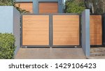 Small photo of Automatic swing open front gates with horizontal wooden slats
