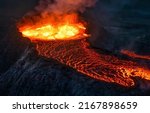Boiling lava erupts from a...