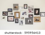 White wall with photos of the...