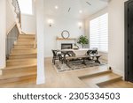 Small photo of interior dining room with a staircase and front entry foyer wrought iron hand rails