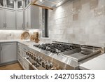 Small photo of Interior modern farmhouse kitchen and dining room with white countertops bar stools large dining table stainless appliances and view to living room with vaulted ceiling