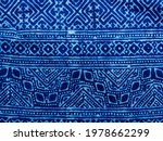 Indigo blue fabric tie dye pattern background. Indigo-Dyed fabric texture with abstract ethnic graphic motif pattern.
