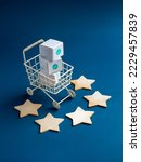 Small photo of Shopping online business, e-commerce, delivery and customer review concepts. Green checkmark icon on white parcel boxes in shopping trolley cart with five stars rating on blue background, vertical.