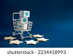 Small photo of Shopping online business, e-commerce, delivery and customer review concepts. Green checkmark icon on white parcel boxes in shopping trolley cart with five stars rating on blue background with space.