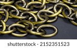 Small photo of Anodized metal chain, jewelry. The chain is a sequential assembly of connected parts that have a common rope character, since it is flexible and curved.