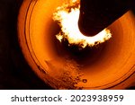 Close up of flame in rotary kiln during heating mode in cement plant