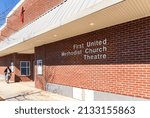 Small photo of GASTONIA, NC, USA-3 MARCH 2022: First United Methodist Church Theatre, diagonal front view, with one man entering the building.