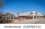 Small photo of FORT MILL, S.C.-2 APRIL 22: Wide angle view of Main St. with residents enjoying springtime in Confederate Park, and row of downtown buildings.