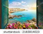 Small photo of Calella de Palafrugell, Spain - June 2 2022: View through an open window with shutters of the whitewashed Costa Brava village as the sun sets on the Catalonian coast of Southern Spain.